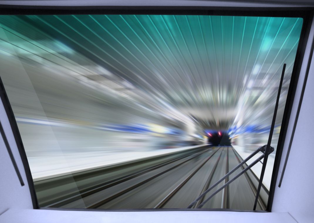Vista desde la cabina de un tren bala Shinkansen entrando a un túnel a alta velocidad.