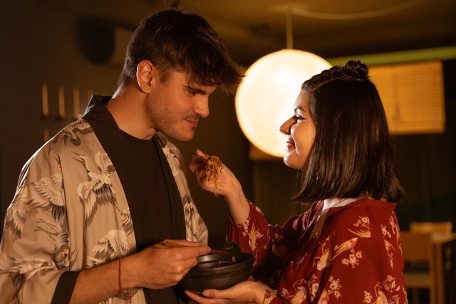 Pareja compartiendo comida japonesa